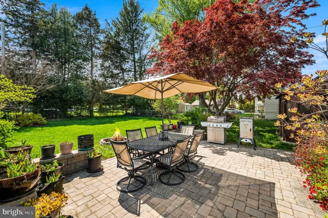 a view of a tables and chairs under an umbrella