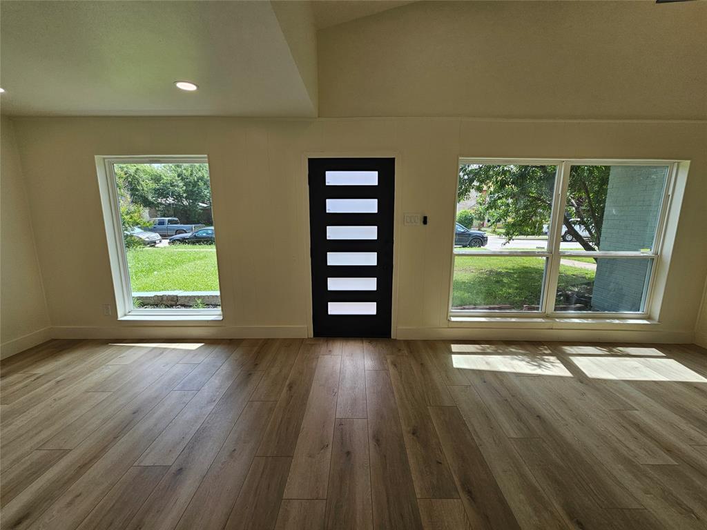 1725 R Avenue, Unit 1727 Plano, TX 75074 - Photo 2 of 20 Entryway featuring a modern black door with five horizontal lites, flanked by two large windows