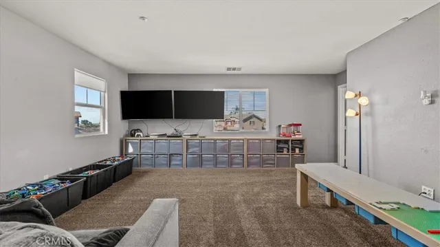 a bedroom with furniture and a flat screen tv