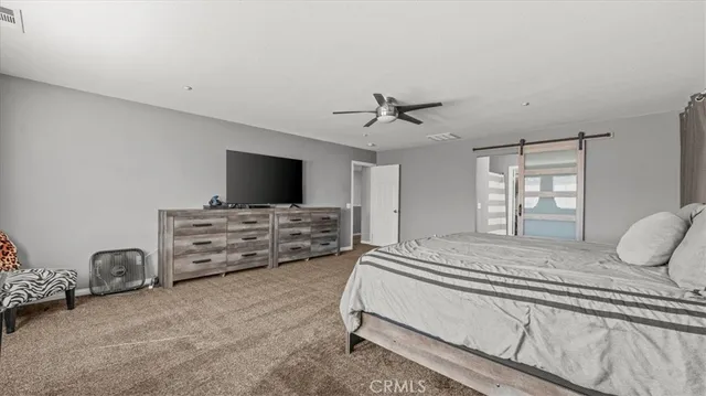 a bedroom with furniture and flat screen tv