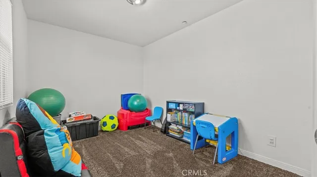 a bedroom with a bed a couch and toys