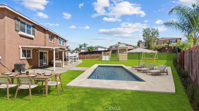 a view of a house with a yard patio and swimming pool