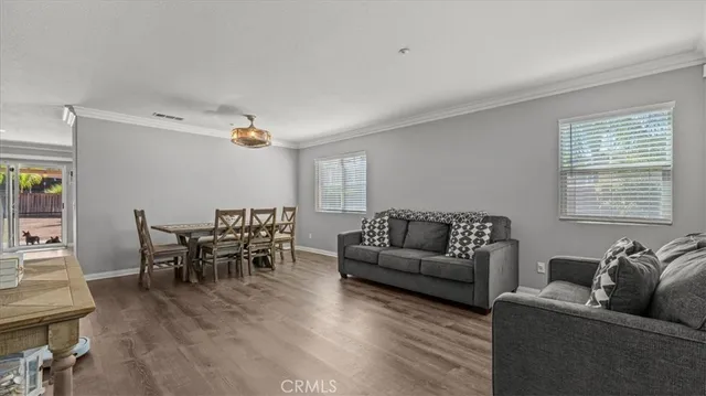 a living room with furniture and a dining table