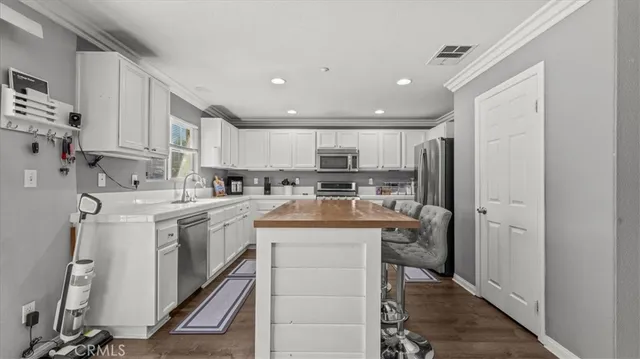 a kitchen with a sink a refrigerator and cabinets