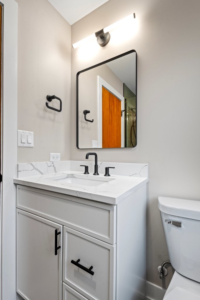 1619 North 20th Avenue Melrose Park, IL 60160 - Photo 11 of 40 a bathroom with a toilet sink and mirror