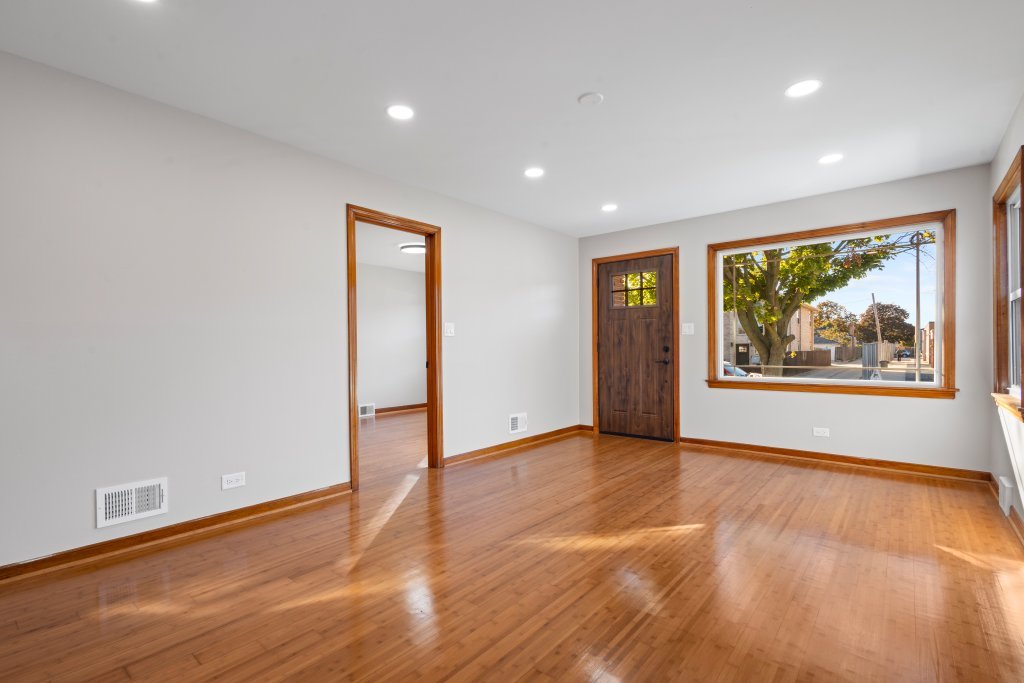 1619 North 20th Avenue Melrose Park, IL 60160 - Photo 3 of 40 a view of an empty room with wooden floor and window