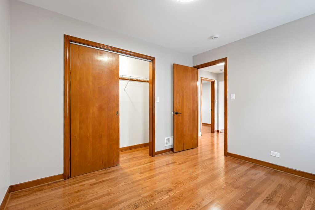 1619 North 20th Avenue Melrose Park, IL 60160 - Photo 9 of 40 a view of an empty room with wooden floor and a window