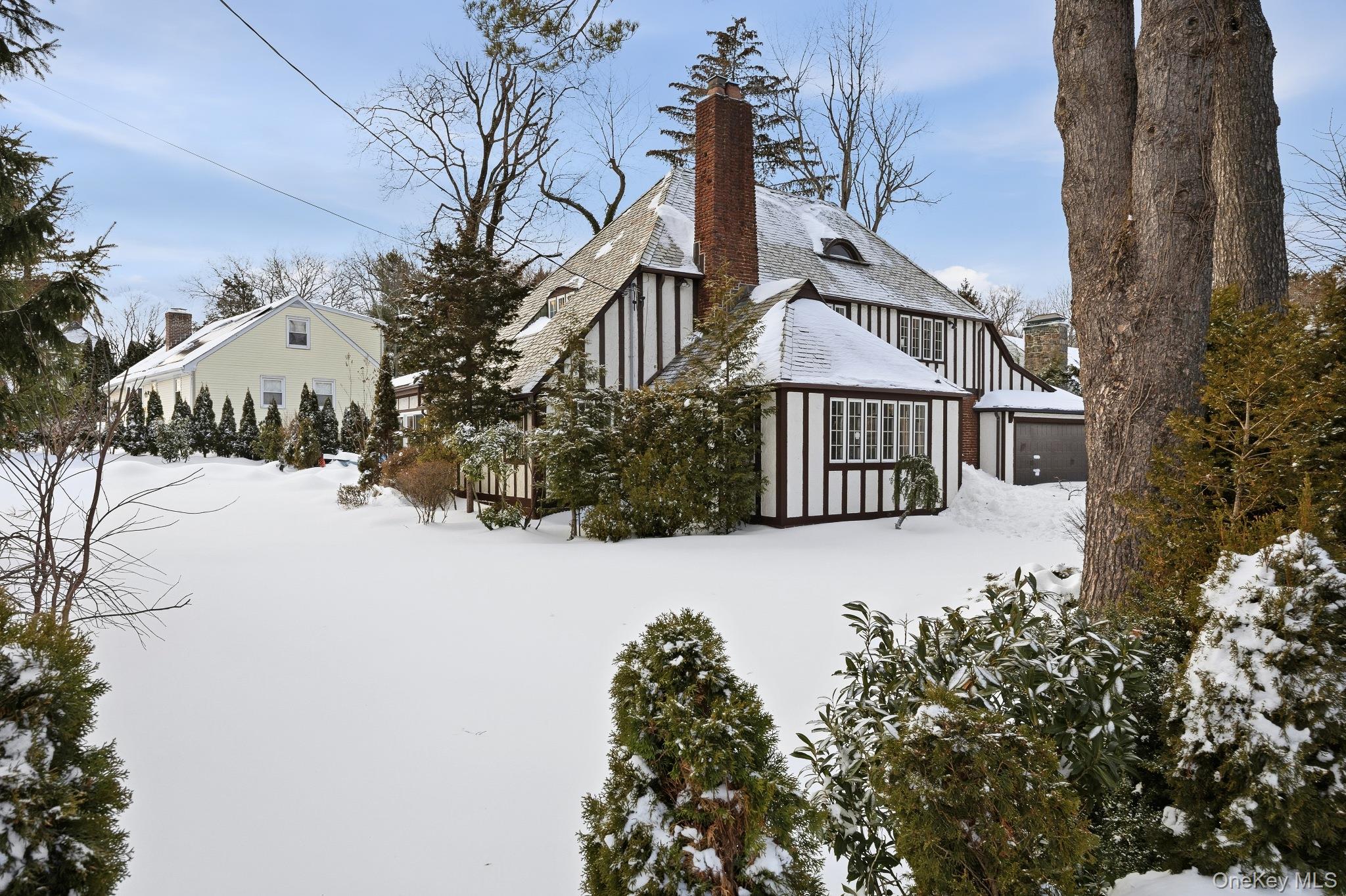 2 Wynmor Road Scarsdale, NY 10583 - Photo 2 of 38 a front view of a house with a yard covered with snow