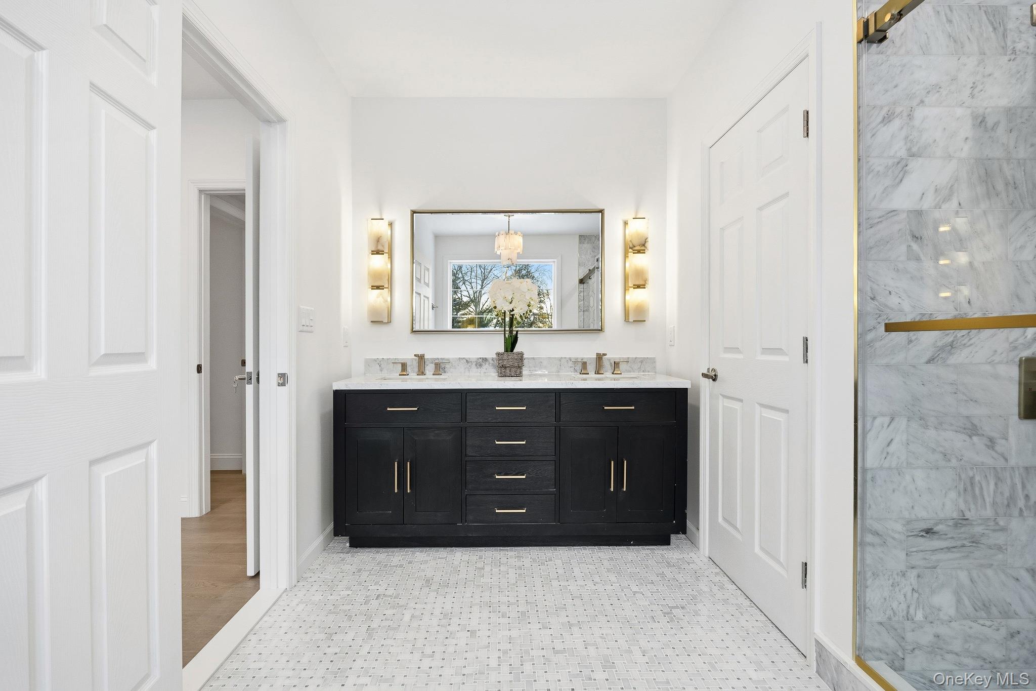 2 Wynmor Road Scarsdale, NY 10583 - Photo 23 of 38 a bathroom with a vanity a sink a mirror a vanity and a shower