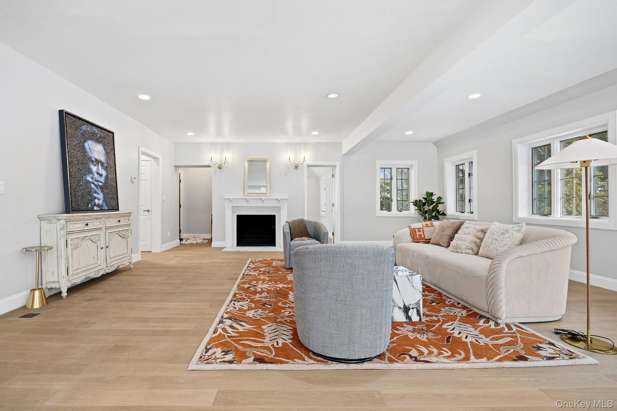 2 Wynmor Road Scarsdale, NY 10583 - Photo 5 of 38 a living room with furniture a fireplace and a kitchen view