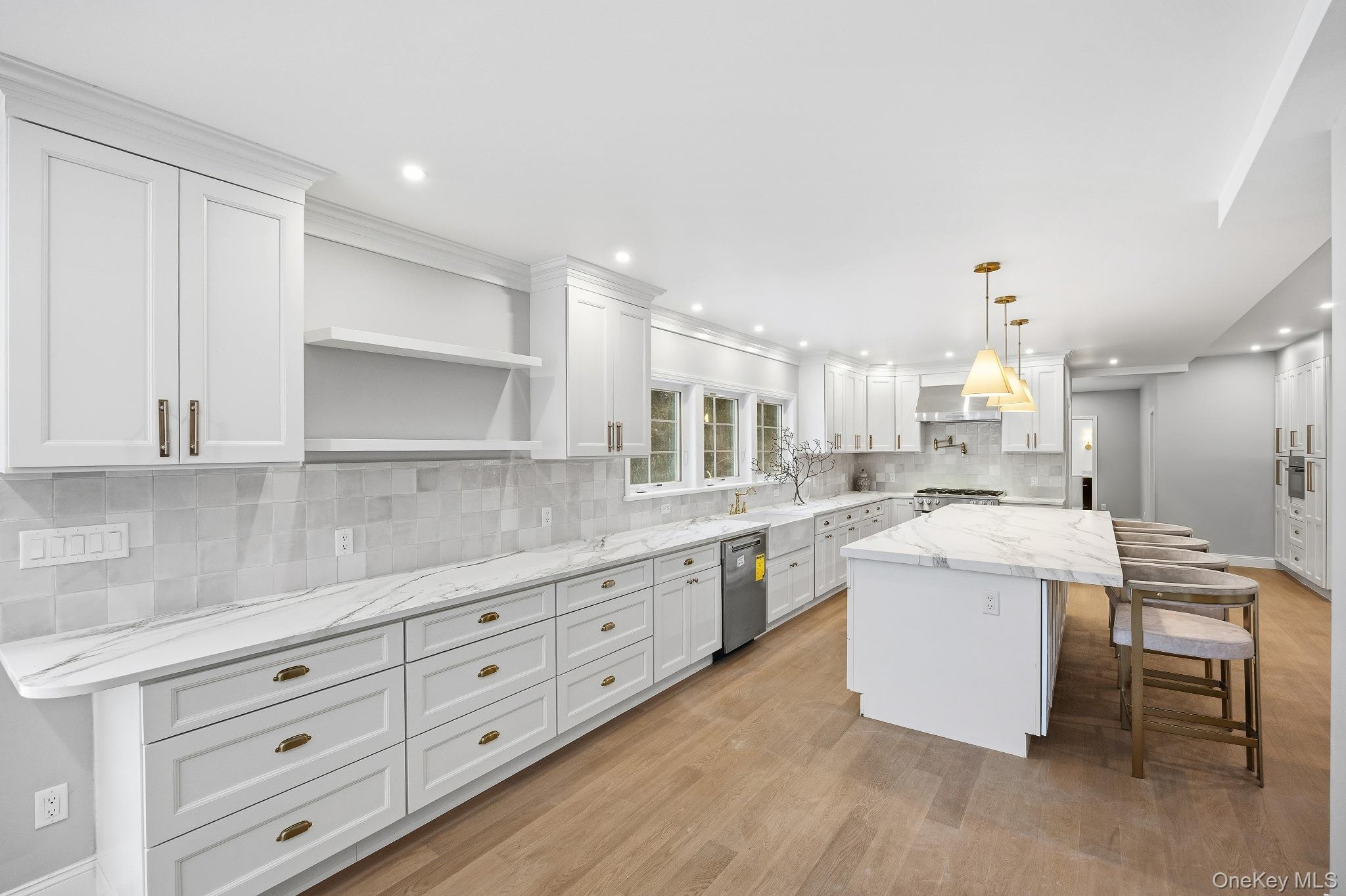 2 Wynmor Road Scarsdale, NY 10583 - Photo 7 of 38 a kitchen with a white cabinets and chandelier