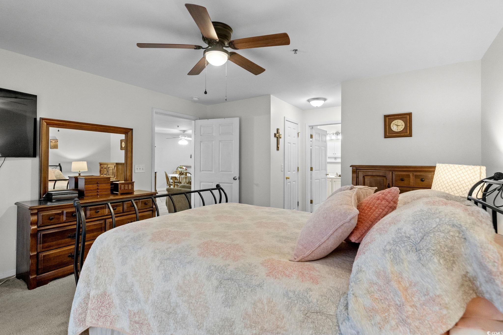 4849 Meadowsweet Drive, Unit 1606 Myrtle Beach, SC 29579 - Photo 19 of 36 Bedroom featuring light carpet, ceiling fan, a closet, and ensuite bathroom