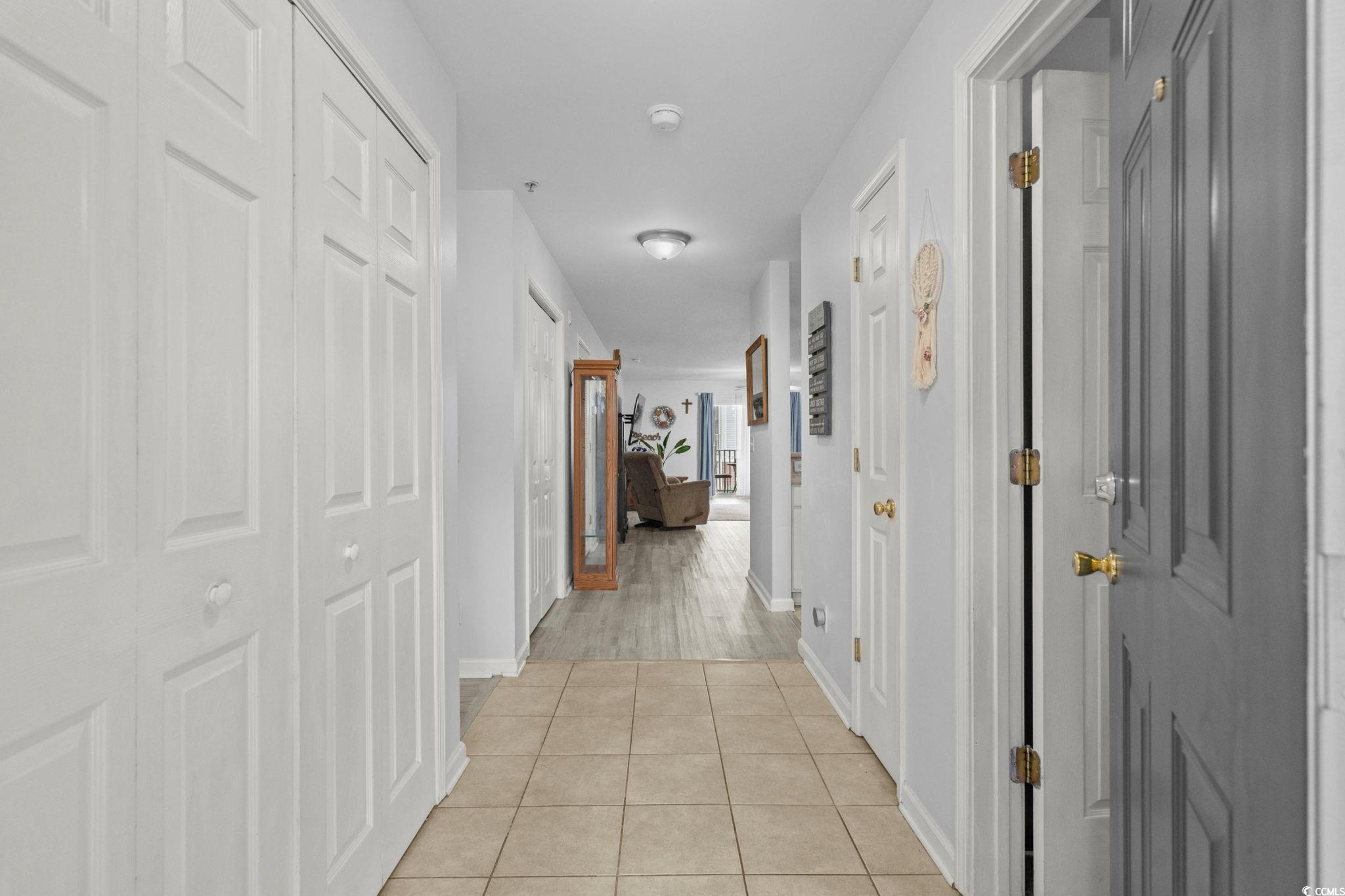 4849 Meadowsweet Drive, Unit 1606 Myrtle Beach, SC 29579 - Photo 4 of 36 Corridor with light tile patterned floors and baseboards