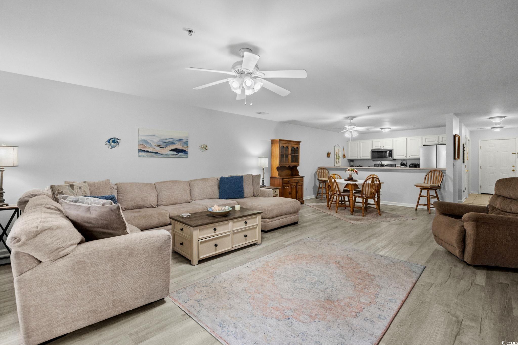 4849 Meadowsweet Drive, Unit 1606 Myrtle Beach, SC 29579 - Photo 9 of 36 Living room with light wood-type flooring and ceiling fan