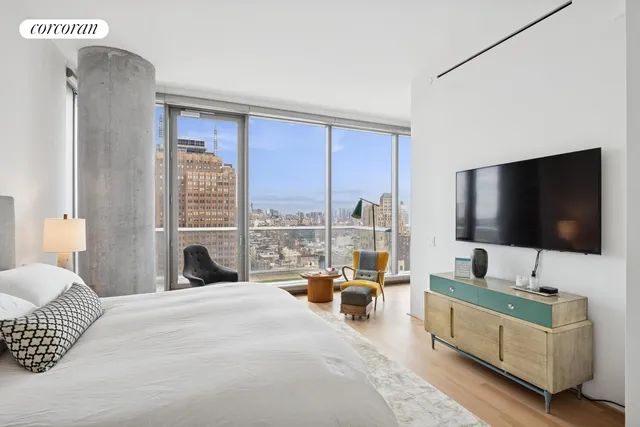 a kitchen with a sink a counter top space and living room view