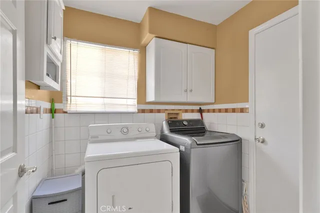 a view of bathroom with a washer and dryer