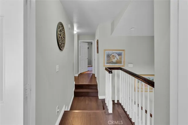 a view of a hallway with wooden floor and a large window
