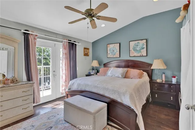 a bedroom with a large bed and a chandelier