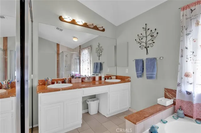 a bathroom with a double vanity sink mirror and toilet