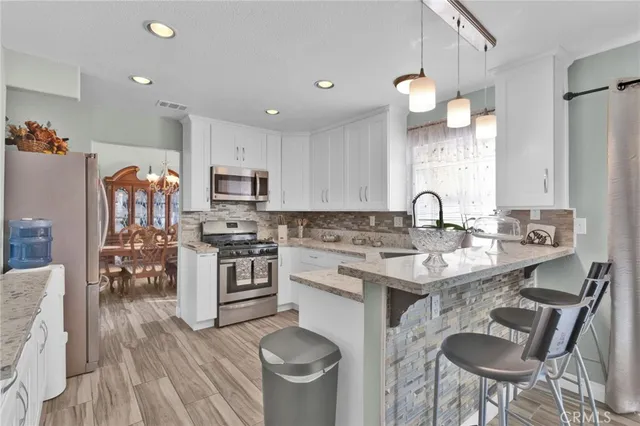 a kitchen with a sink stove and refrigerator