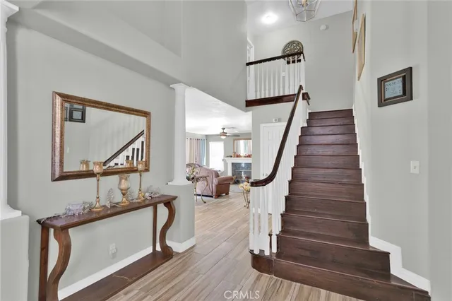 a view of entryway and hall with wooden floor