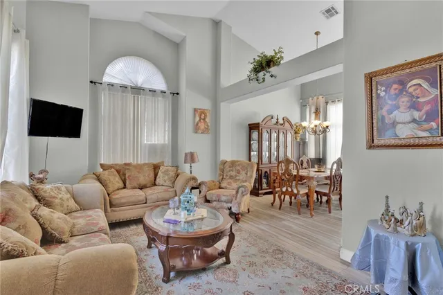 a living room with furniture a rug and a chandelier