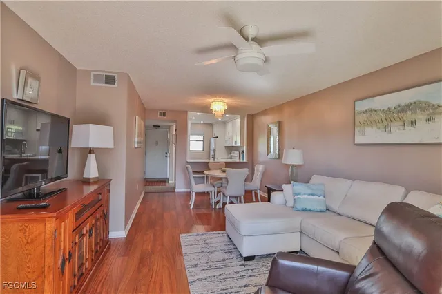 a living room with fireplace furniture and a wooden floor