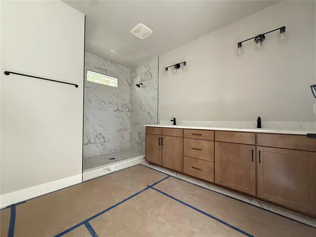 a bathroom with a shower and vanity