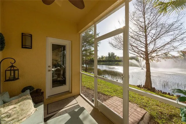 a view of a porch with a floor to ceiling window next to a yard