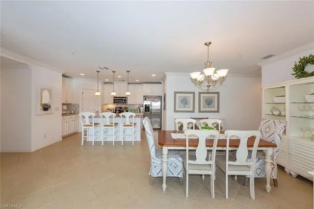 a view of a dining room with furniture and chandelier