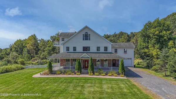 a front view of a house with a yard table and chairs