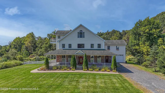 a front view of a house with a yard table and chairs