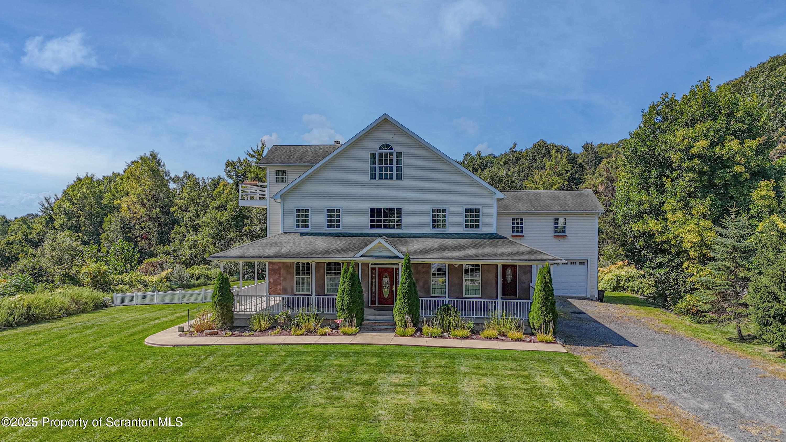 a front view of a house with a yard table and chairs