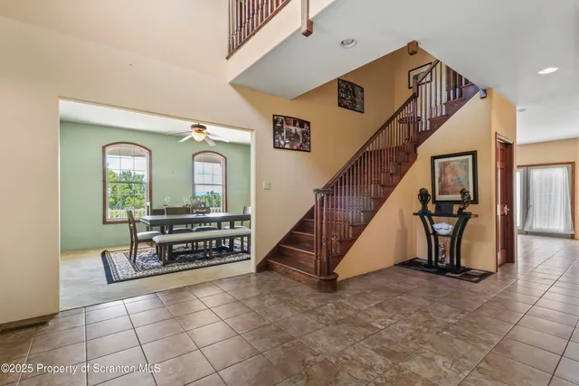 a view of staircase with furniture and a chandelier