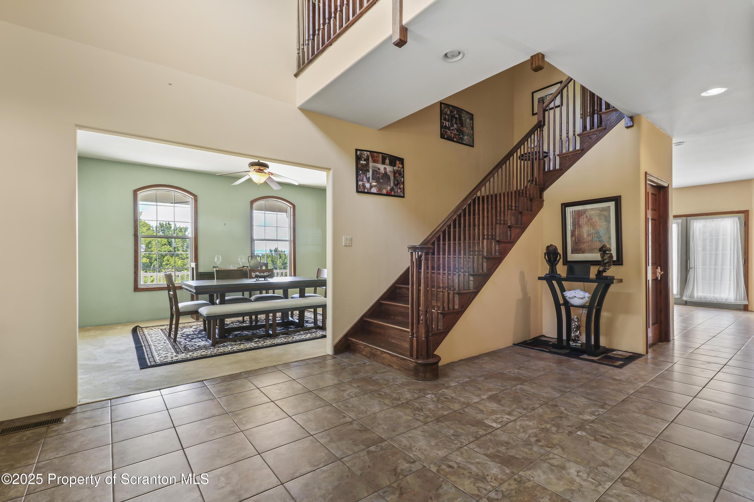 107 Ridgeview Drive Scranton, PA 18504 - Photo 14 of 48 a view of staircase with furniture and a chandelier