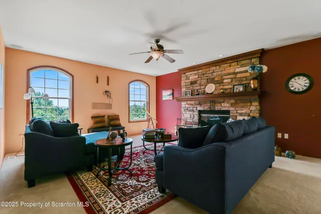 a living room with furniture a rug and a window