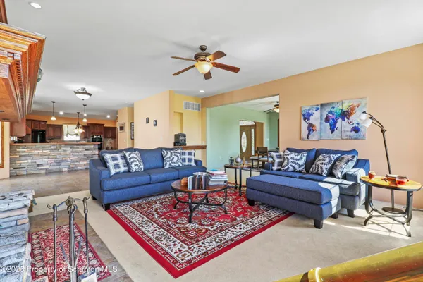 a living room with furniture a rug and a chandelier