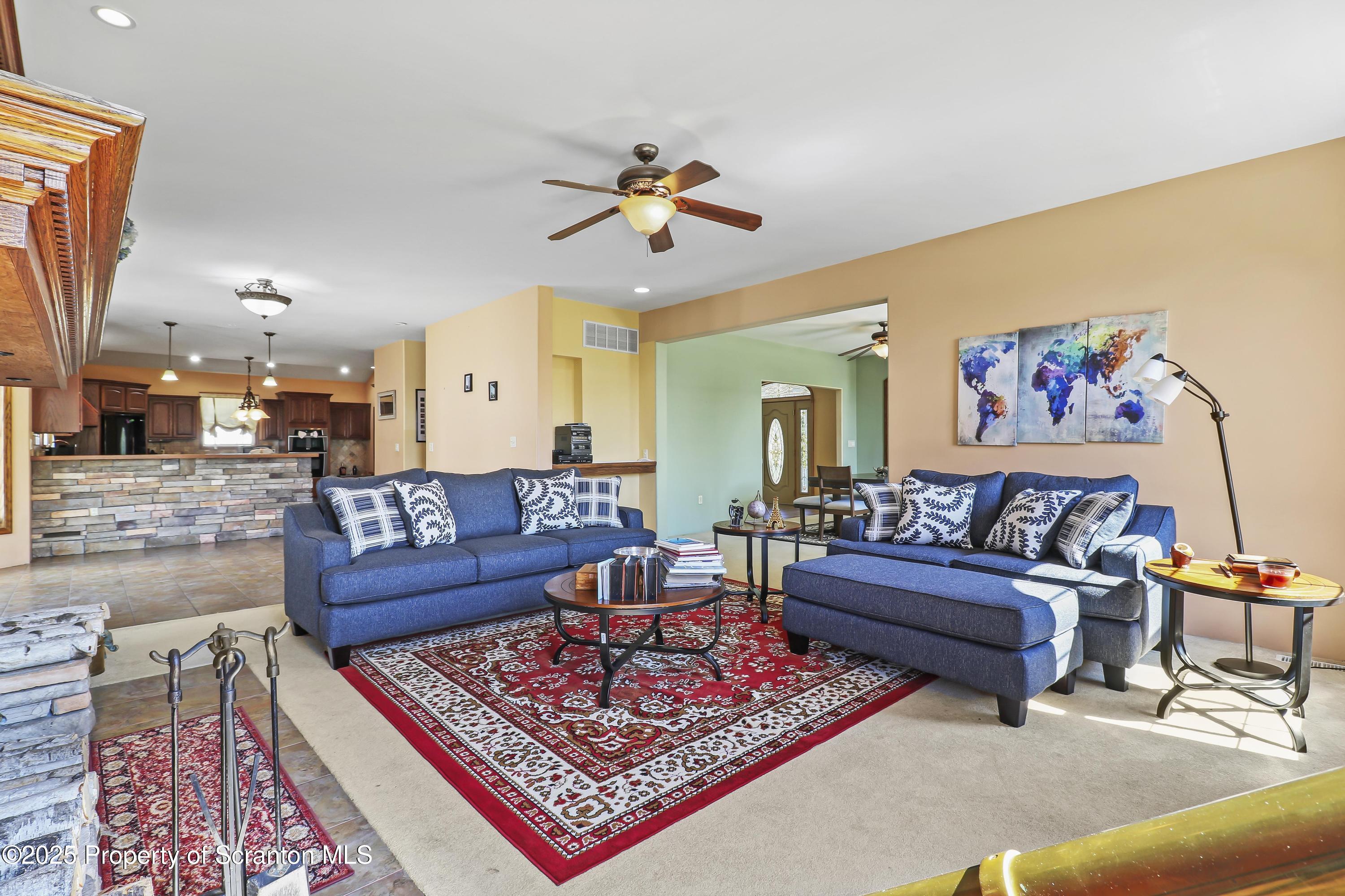 107 Ridgeview Drive Scranton, PA 18504 - Photo 21 of 48 a living room with furniture a rug and a chandelier