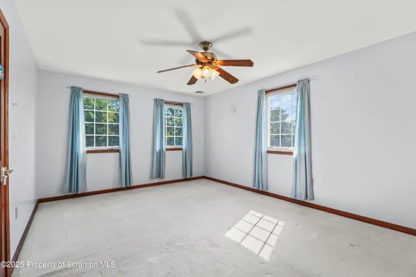 a bedroom with a bed and glass walk in closet