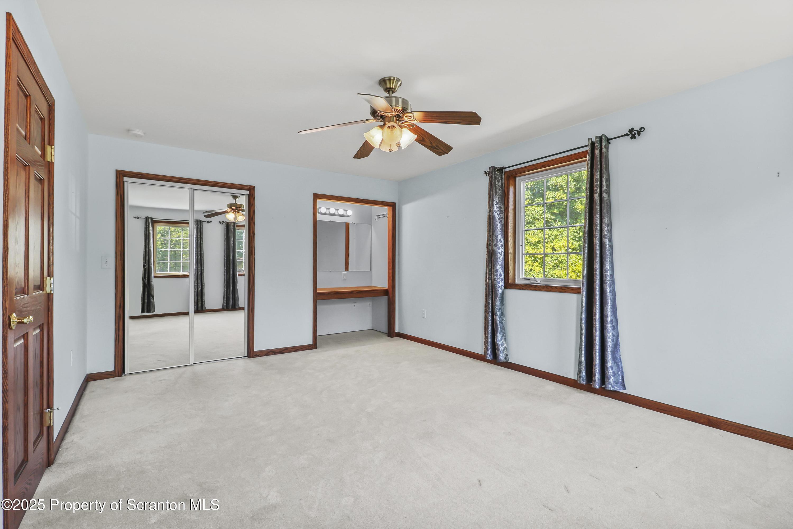 107 Ridgeview Drive Scranton, PA 18504 - Photo 35 of 48 a view of a big room with windows and chandelier fan