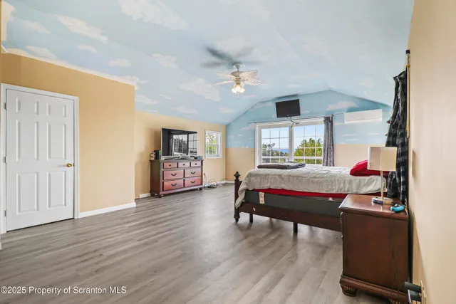 a bedroom with a bed and a chandelier