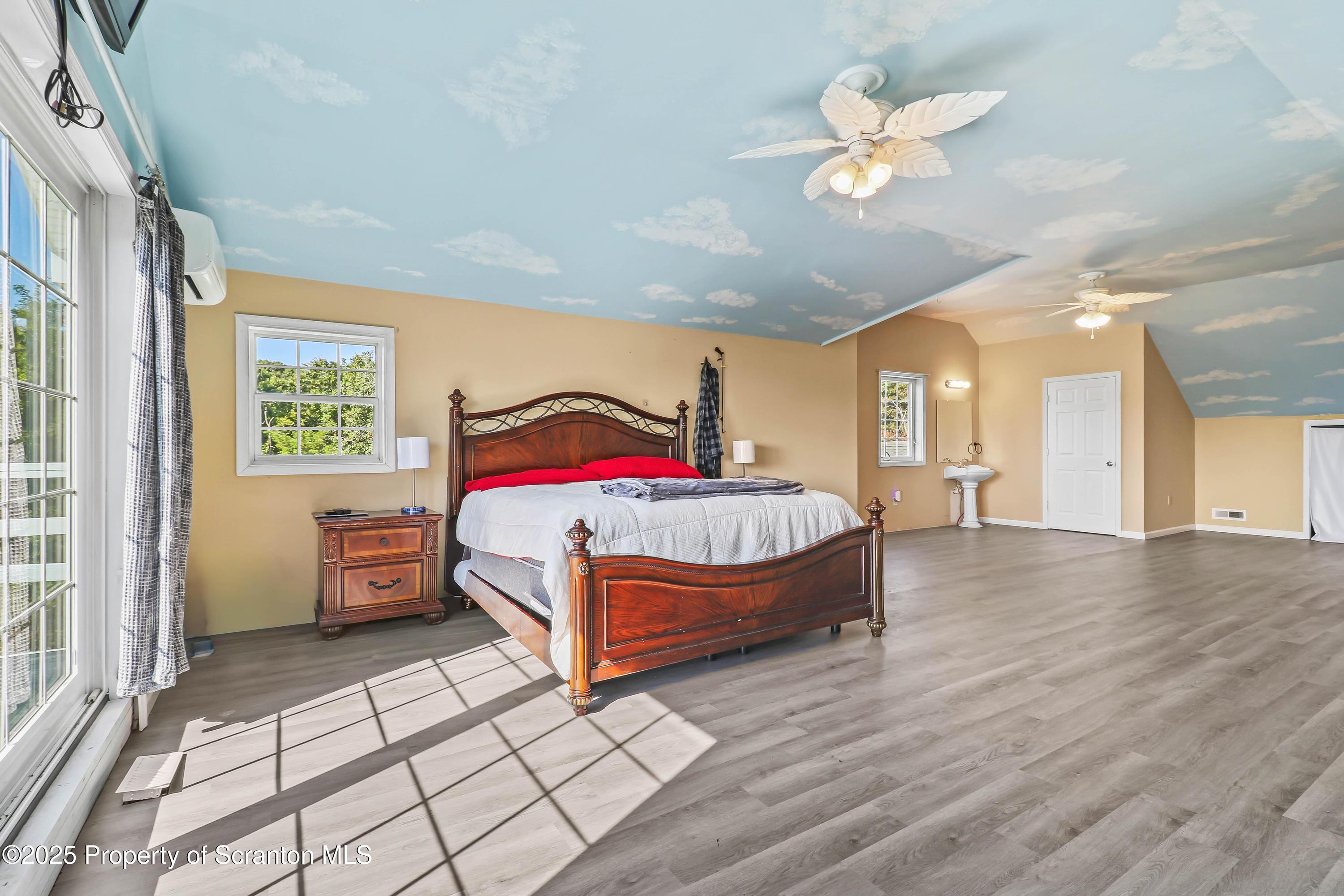 107 Ridgeview Drive Scranton, PA 18504 - Photo 38 of 48 a bedroom with a bed and a chandelier