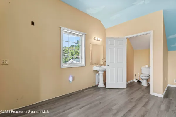 a large room with a window and wooden floor