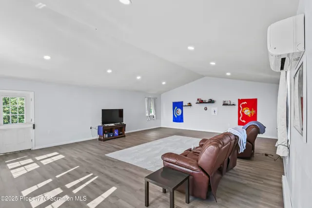 a living room with couch and a view of kitchen