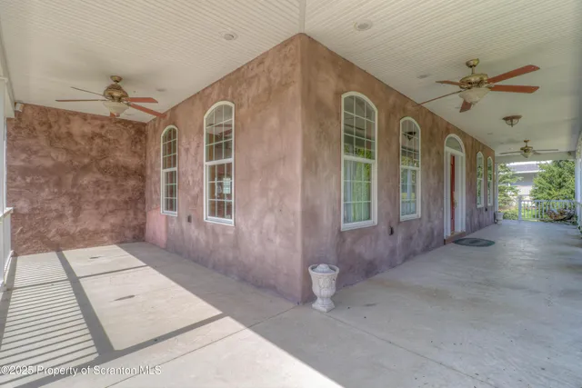 a view of a brick house with a chairs and a table