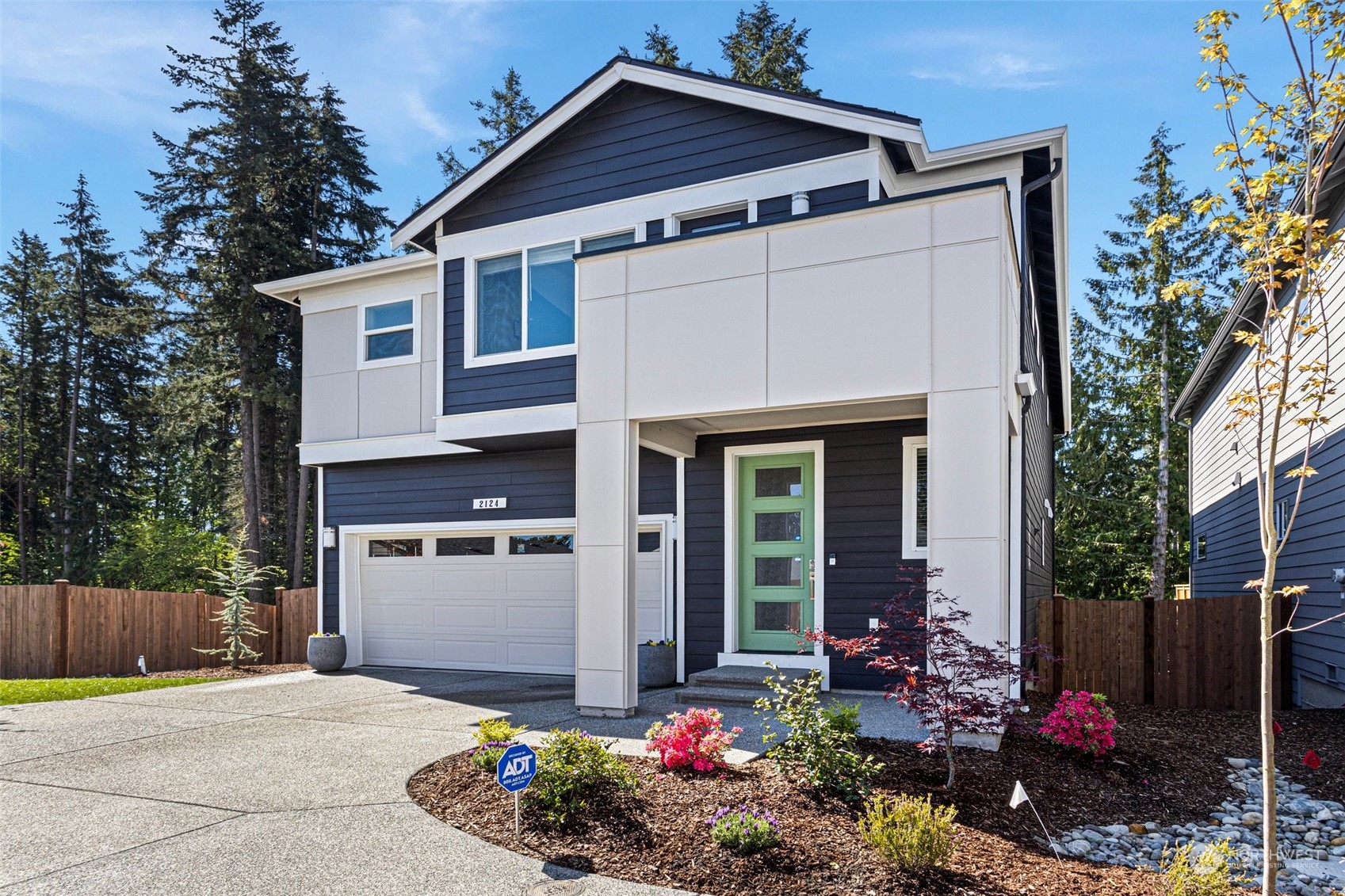 2124 229th Place Southwest Bothell, WA 98021 - Photo 1 of 37 a front view of a house with a yard