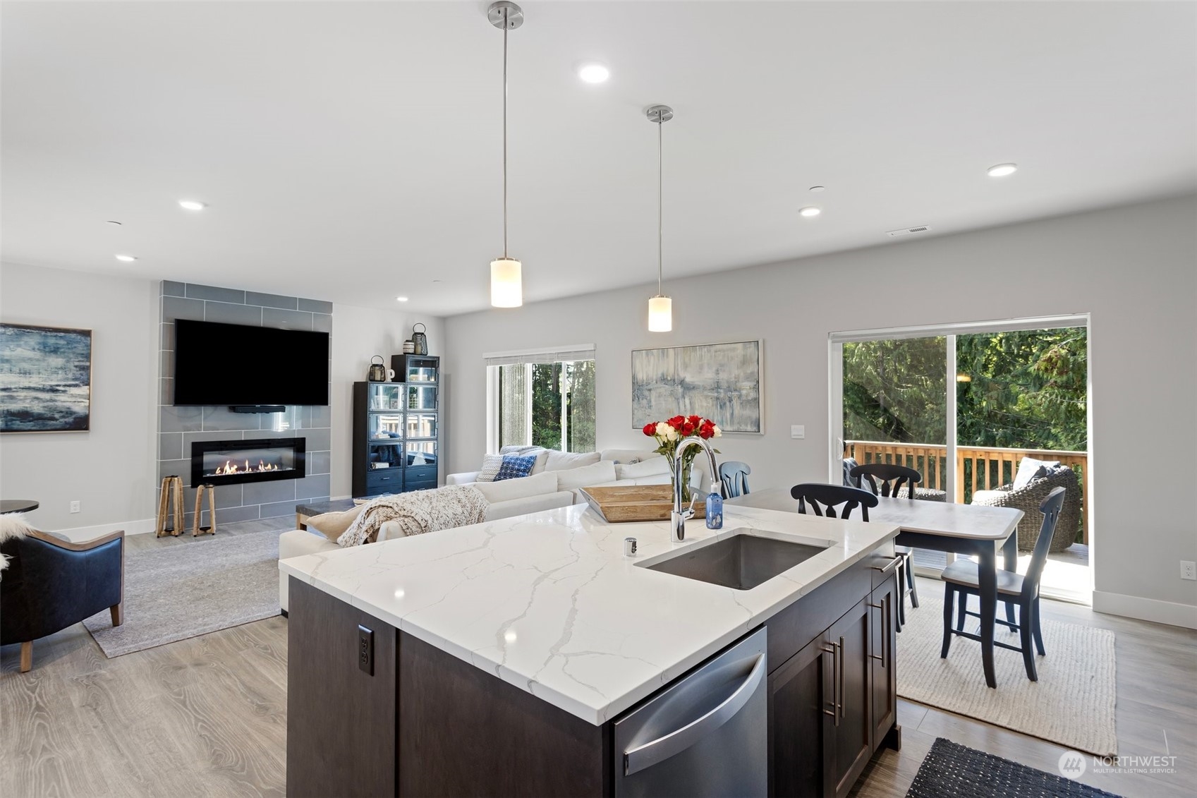 2124 229th Place Southwest Bothell, WA 98021 - Photo 11 of 37 a kitchen with a stove a center island a dining table and chairs