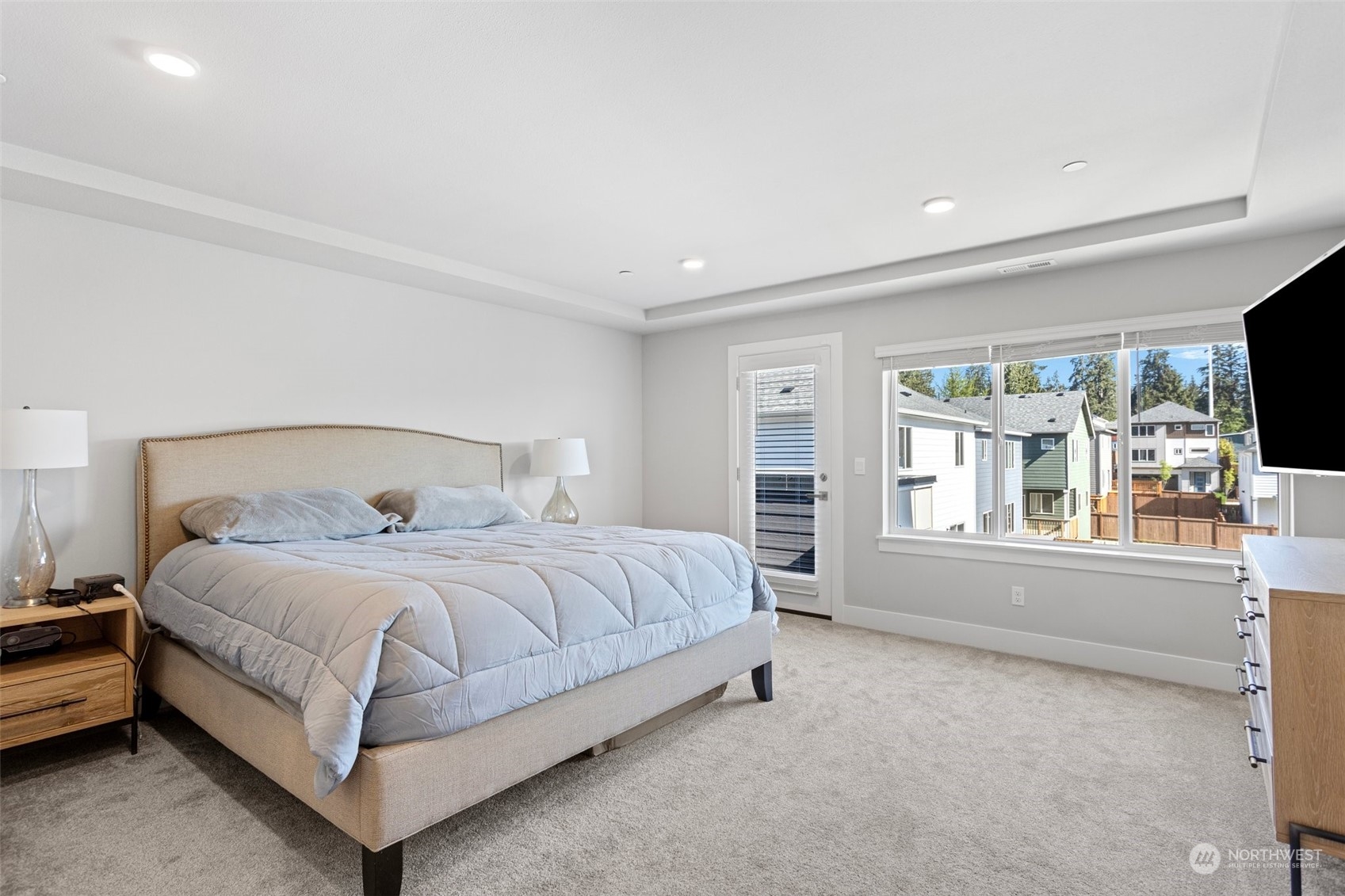 2124 229th Place Southwest Bothell, WA 98021 - Photo 12 of 37 a bedroom with a large bed and a flat tv screen on a dresser