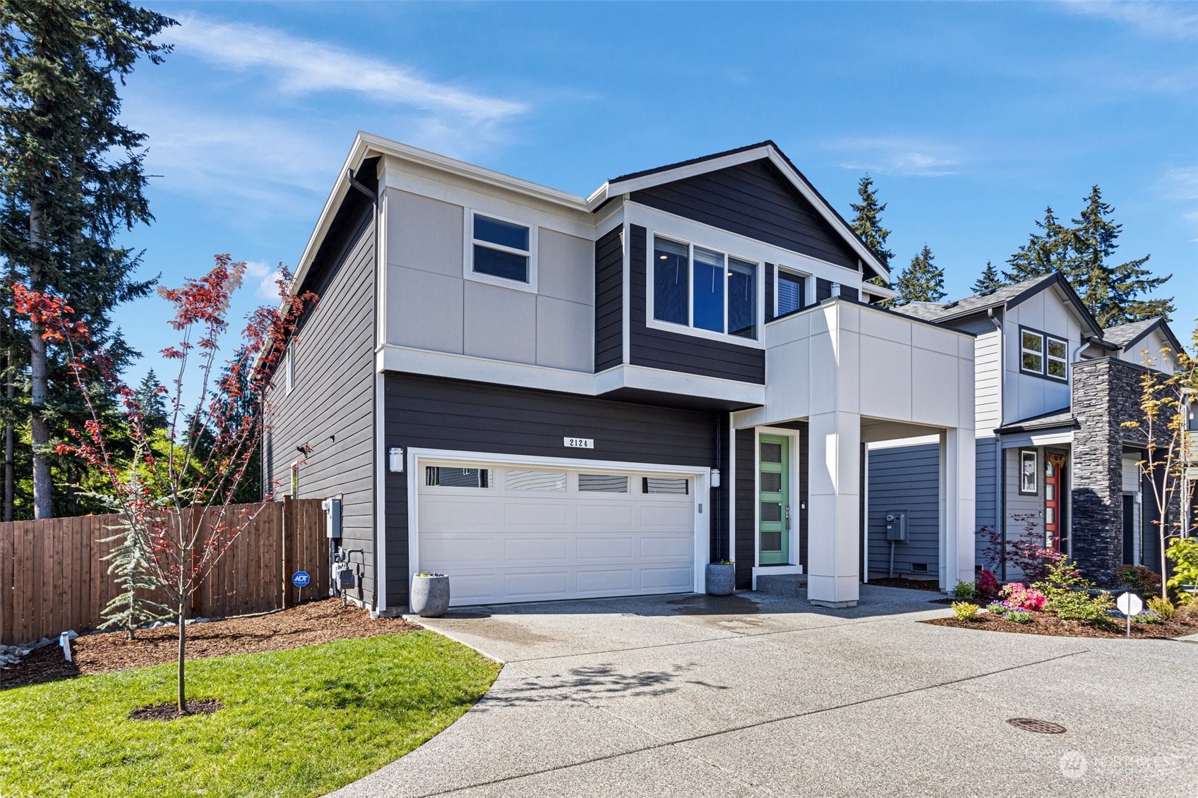 2124 229th Place Southwest Bothell, WA 98021 - Photo 2 of 37 a front view of a house with a yard and potted plants