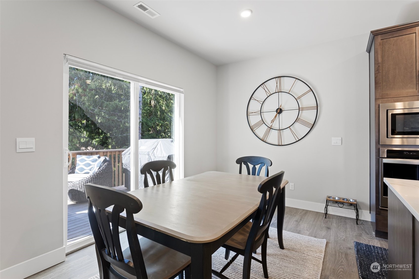 2124 229th Place Southwest Bothell, WA 98021 - Photo 24 of 37 a view of a dining room with furniture window and wooden floor